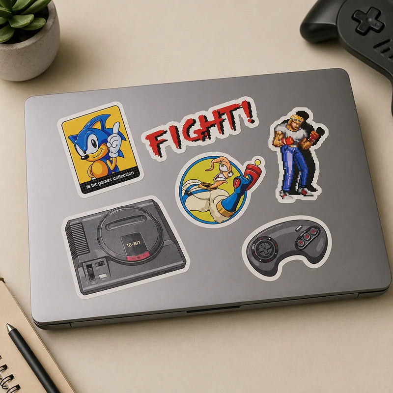 Laptop with gaming-themed stickers on a beige surface